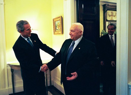 President George W. Bush welcomes Prime Minister Ariel Sharon of Israel to the White House Wednesday, April 14, 2004. The two leaders met in the residence before holding a joint press conference. Pictured behind the Prime Minister is U.S. Department of State Chief of Protocol Donald Ensenat. White House photo by Eric Draper.