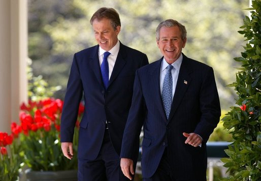President George W. Bush and Prime Minister Tony Blair walk along the colonnade before a press conference in the Rose Garden of the White House on April 16, 2004. White House photo by Paul Morse.