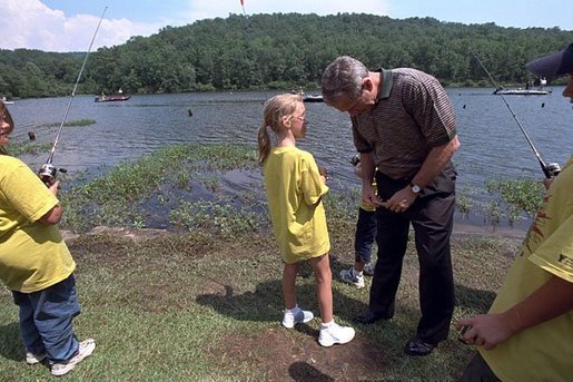 During a visit to Oak Mountain State Park, President Bush confers with a young YMCA day camper June 21, 2001. White House photo by Eric Draper.