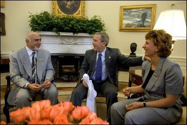 President George W. Bush meets with the newly-elected President of the National Olympic Committee of Iraq, Ahmed Al-Samarrai, left, and Dr. Iman Sabeeh, member of the Executive Office of the NOCI, in the Oval Office Monday, April 19, 2004.  White House photo by Eric Draper.