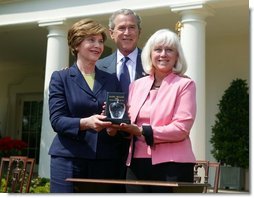 President George W. Bush and First Lady Mrs. Laura Bush with Kathleen Mellor the 2004 Teacher of the Year from South Kingstown, Rhode Island in the Rose Garden of the White House on April 21, 2004.  White House photo by Paul Morse