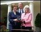 President George W. Bush and First Lady Mrs. Laura Bush with Kathleen Mellor the 2004 Teacher of the Year from South Kingstown, Rhode Island in the Rose Garden of the White House on April 21, 2004. White House photo by Paul Morse