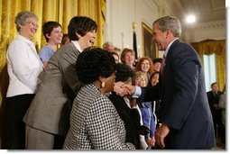 President George W. Bush greets breast cancer survivors at a reception for the National Race for the Cure in the East Room of the White House on April 21, 2004.  White House photo by Paul Morse