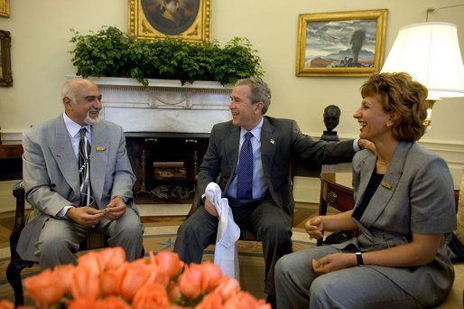President George W. Bush meets with the newly-elected President of the National Olympic Committee of Iraq, Ahmed Al-Samarrai, left, and Dr. Iman Sabeeh, member of the Executive Office of the NOCI, in the Oval Office Monday, April 19, 2004. White House photo by Eric Draper.
