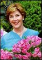 Laura Bush poses with the newly-named "Tulipa Laura Bush" April 22, 2004. Earlier in the day, Mrs. Bush participated in an official naming ceremony at the Washington, D.C., residence of the Dutch Ambassador. White House photo by Tina Hager.