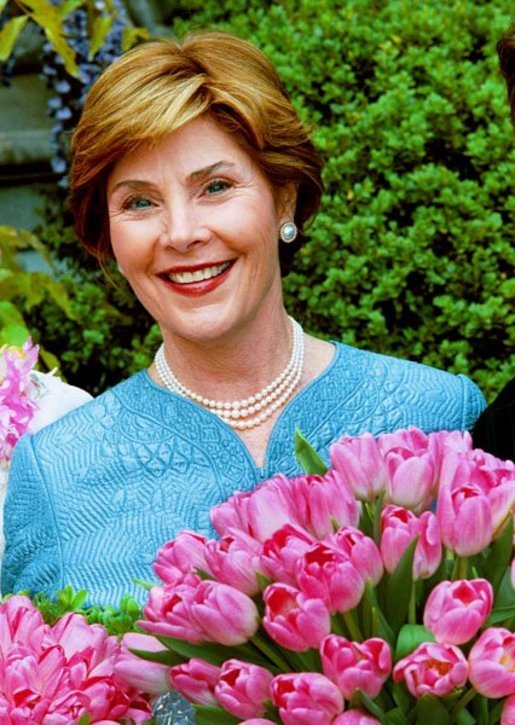 Laura Bush poses with the newly-named "Tulipa Laura Bush" April 22, 2004. Earlier in the day, Mrs. Bush participated in an official naming ceremony at the Washington, D.C., residence of the Dutch Ambassador. White House photo by Tina Hager.
