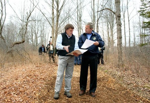 President George W. Bush looks over maps of the Wells National Estuarine Research Reserve with Manager Paul Dest in Wells, Maine, Thursday, April 22, 2004. White House photo by Eric Draper.