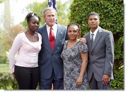 President George W. Bush congratulates the Groundwork Providence Environmental Team of Providence, R.I., on receiving the President’s Environmental Youth Award in the East Garden April 22, 2004. Members of the team include, from left to right, Olabisi Davies, 17, Taja Gonsalves, 15, and Miguel Blanco, 16.  White House photo by Susan Sterner