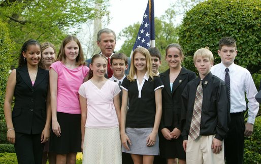 President George W. Bush congratulates the West Branch Middle School Science Club of West Branch, Iowa, on receiving the President’s Environmental Youth Award in the East Garden April 22, 2004. White House photo by Susan Sterner.