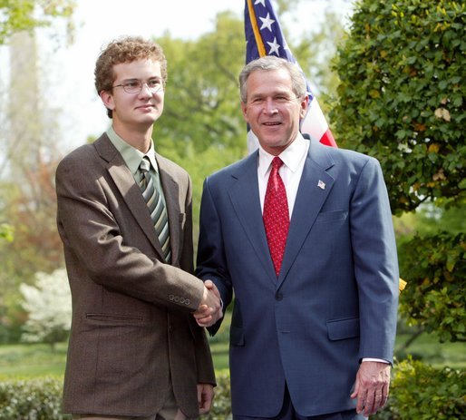 President George W. Bush congratulates Andrew Rominger, 17, of Albuquerque, N.M., on receiving the President’s Environmental Youth Award in the East Garden April 22, 2004. White House photo by Susan Sterner.