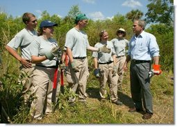 President George W. Bush talks with AmeriCorps volunteers at Rookery Bay National Estuarine Research Reserve in Naples, Fla., Friday, April 22, 2004. "Here at Rookery Bay, you see how important wetlands are to protecting 150 species of birds, and many threatened and endangered animals," said the President in his remarks.   White House photo by Eric Draper