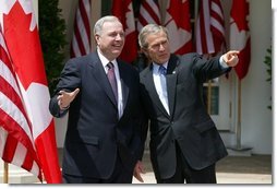 President George W. Bush and Canadian Prime Minister Paul Martin respond to questions from the press corps in the Rose Garden after a meeting at the White House on April 30, 2004.  White House photo by Paul Morse