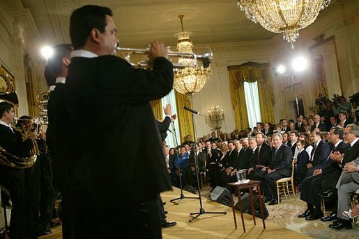President George W. Bush listens to Banda El Recodo during a White House ceremony honoring Cinco de Mayo in the East room Wednesday, May 5, 2004. Mexican recording artists Marco Antonio Solis and Jimena also performed during the event. White House photo by Paul Morse