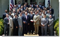 President George W. Bush with the Super Bowl Champion New England Patriots and owner Bob Kraft and coach Bill Belichick during a photo opportunity in the Rose Garden on May 10, 2004.  White House photo by Paul Morse