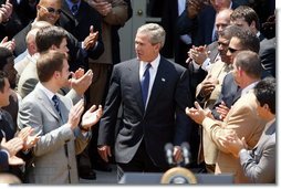 President George W. Bush is congratulated by the Super Bowl Champion New England Patriots before welcoming them to a photo opportunity the Rose Garden on May 10, 2004.  White House photo by Paul Morse