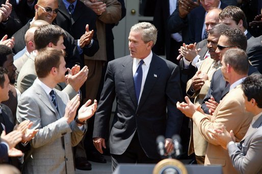 President George W. Bush is congratulated by the Super Bowl Champion New England Patriots before welcoming them to a photo opportunity the Rose Garden on May 10, 2004. White House photo by Paul Morse