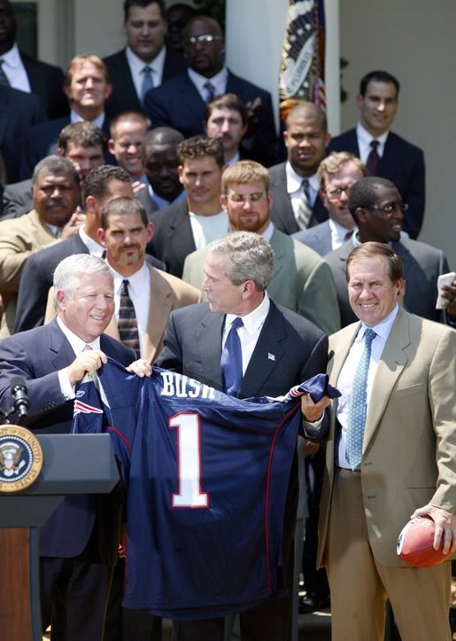 President George W. Bush receives a jersey from New England Patriots owner Bob Kraft and coach Bill Belichick during a photo opportunity with the Super Bowl champions in the Rose Garden on May 10, 2004. White House photo by Paul Morse