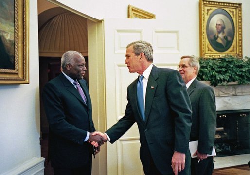 President George W. Bush welcomes President Jose Eduardo dos Santos of Angola to the Oval Office Wednesday, May 12, 2004. White House photo by Eric Draper