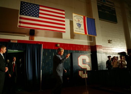 President George W. Bush salutes law enforcement officers before participating in a conversation on High School Initiatives at Parkersburg South High School in Parkersburg, W. Va., Thursday, May 13, 2004. White House photo by Paul Morse