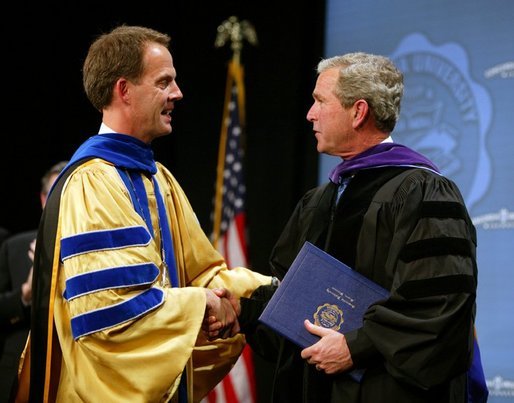 President George W. Bush is congratulated upon receiving an honorary doctorate degree during the commencement ceremonies for Concordia University near Milwaukee, Wis., Friday, May 14, 2004. White House photo by Paul Morse.