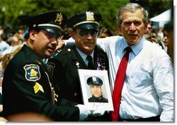 President George W. Bush stands for pictures during the Annual Peace Officers' Memorial Service at the U.S. Capitol in Washington, D.C., Saturday, May 15, 2004. "Our fallen officers died in service to justice, and in defense of the innocent," said President Bush. "They will never be forgotten by their comrades, they will never be forgotten by their country."  White House photo by Paul Morse
