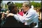 President George W. Bush talks with a woman attending the Annual Peace Officers' Memorial Service at the U.S. Capitol in Washington, D.C., Saturday, May 15, 2004. White House photo by Paul Morse