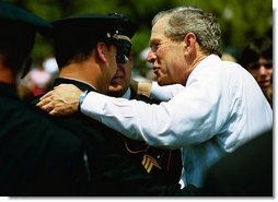President George W. Bush talks with officers at the Annual Peace Officers' Memorial Service at the U.S. Capitol in Washington, D.C., Saturday, May 15, 2004. "In the Memorial, and in countless acts of love and kindness, the fallen are remembered and honored. And this afternoon, on behalf of all Americans, I offer the respect of a grateful nation," said the President. "Their calling in life was to keep the peace."  White House photo by Paul Morse
