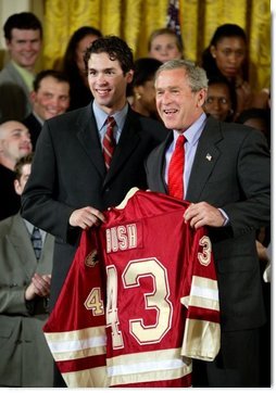 President George W. Bush stands with Ryan Caldwell of the University of Denver men's hockey team during a ceremony in the East Room congratulating four NCAA teams for winning national titles Wednesday, May 19, 2004.  White House photo by Paul Morse