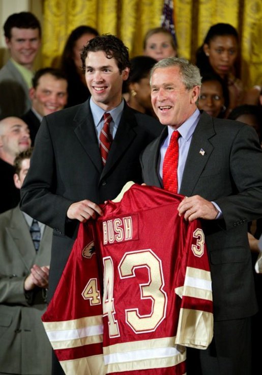 President George W. Bush stands with Ryan Caldwell of the University of Denver men's hockey team during a ceremony in the East Room congratulating four NCAA teams for winning national titles Wednesday, May 19, 2004. White House photo by Paul Morse.