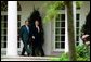 After meeting in the Oval Office, President George W. Bush and Prime Minister Konstandinos Karamanlis of Greece visit the Rose Garden Thursday, May 20, 2004. White House photo by Joyce Naltchayan