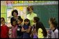 Laura Bush visits with students from Ms. Valdez's first grade reading class at Reginald Chavez Elementary School in Albuquerque, N.M., Thursday, May 20, 2004. In her remarks, Mrs. Bush discussed the Summer Reader's Achievement Program, "And the goal of it is to encourage children in kindergarten through eighth grade to read over the summer, which will mitigate the loss in reading skills that research shows takes place in students, especially low-income students who leave school in the spring and don't pick up a book all summer and then come back in the fall and they really have to start over again on a lot of their reading skills." White House photo by Tina Hager.