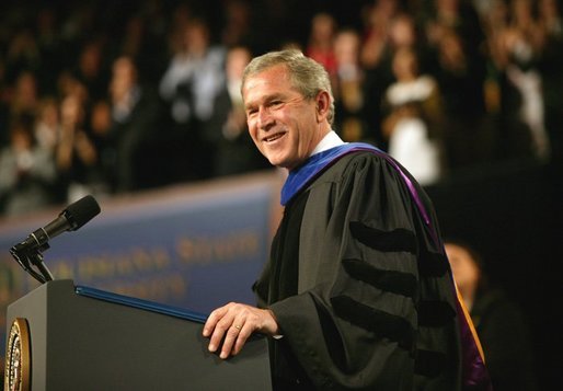 President George W. Bush imparts some light-hearted audience to the graduating students at the Louisiana State University Commencement in Baton Rouge, La., Friday, May 21, 2004. "As you enter professional life, I have a few other suggestions about how to succeed on the job. For starters, be on time. It's polite, and it shows your respect for others. Of course, it's easy for me to say," said the President. "It's easy for me to be punctual when armed men stop all the traffic in town for you." White House photo by Eric Draper.
