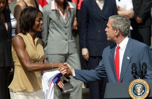 President George W. Bush greets Detroit Shock player Swin Cash during a photo opportunity with the 2003 WNBA champions in the Rose Garden on May 24, 2004. White House photo by Paul Morse.