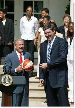 President George W. Bush is presented a signed ball from Detroit Shock coach Bill Laimbeer during a photo opportunity with the 2003 WNBA champions in the Rose Garden on May 24, 2004.  White House photo by Paul Morse