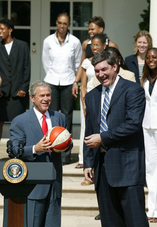 President George W. Bush is presented a signed ball from Detroit Shock coach Bill Laimbeer during a photo opportunity with the 2003 WNBA champions in the Rose Garden on May 24, 2004. White House photo by Paul Morse.