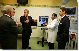President George W. Bush listens to a demonstration by Dr. Neal Patel on the benefits of using information technology in hospitals at Vanderbilt Children’s Hospital in Nashville, Tenn., May 27, 2004.  White House photo by Paul Morse