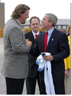 President George W. Bush greets Jason Matthews of the Tennessee Titans NFL team after arriving in Nashville, Tenn., May 27, 2004.  White House photo by Paul Morse