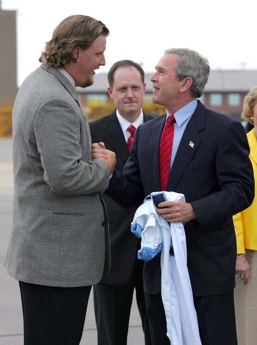 President George W. Bush greets Jason Matthews of the Tennessee Titans NFL team after arriving in Nashville, Tenn., May 27, 2004. White House photo by Paul Morse