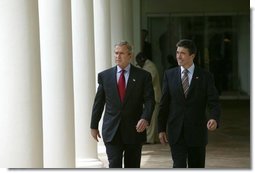 President George W. Bush and Prime Minister Anders Fogh Rasmussen of Denmark walk along the colonnade in Rose Garden after meeting in the Oval Office Friday, May 28, 2004. White House photo by Eric Draper.