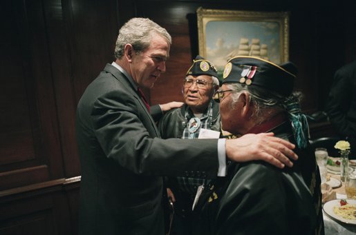 President George W. Bush talks with World War II Veterans Jose Ramos Chavez, left, and his younger brother Joe Diego Chavez, both of Albuquerque, N.M., during the President's drop by at a breakfast with Secretary of Veterans Affairs Anthony Principi, Senator Bob Dole and World War II Veterans in the Executive Dining Room at the White House Friday, May 28, 2004. The brothers served in the Army during WWII. Jose took part in the D-Day invasion at Normandy, France, and Joe served in both the Atlantic and Pacific theaters. White House photo by Eric Draper.