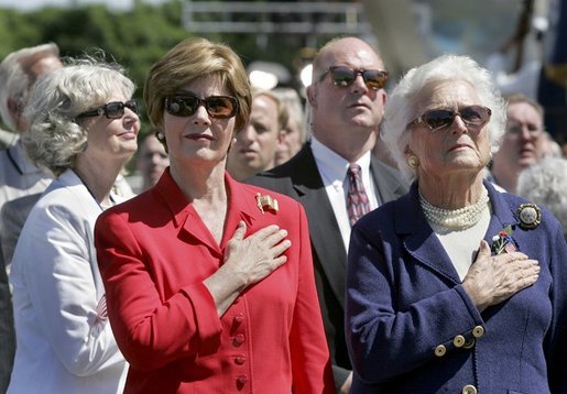 Laura Bush and Former First Lady Barbara Bush stand during the National Anthem at the National World War II Memorial on the National Mall, Saturday, May 29, 2004. White House photo by Eric Draper