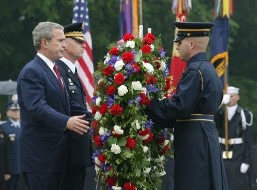 President George W. Bush stands at attention during Wreath Laying ceremonies in commemoration of Memorial Day at Arlington National Cemetery in Arlington, Virginia Monday May 31, 2004. White House photo by Joyce Naltchayan.