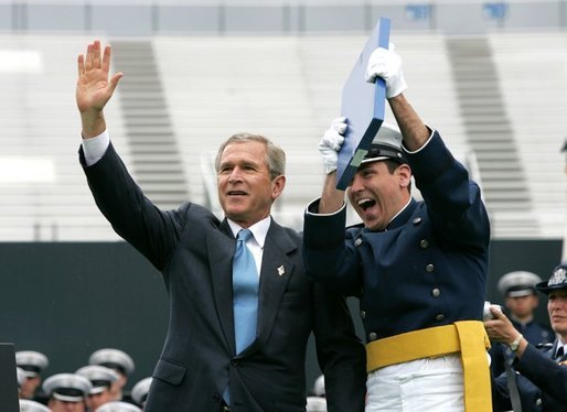 President George W. Bush celebrates with a graduating Air Force Cadet during the United States Air Force Academy Graduation Ceremony in Colorado Springs, Colorado, June 2, 2004. White House photo by Eric Draper.