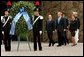 President George W. Bush with Mrs. Bush and Prime Minister of Italy Silvio Berlusconi participate in a wreath laying ceremony at Fosse Ardeatine in Rome, Italy, Friday, June 4, 2004. White House photo by Paul Morse