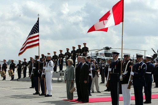 Hosted by Deputy U.S. Chief of Protocol Jeff Eubank, far right, Canadian Prime Minister Paul Martin and his wife Sheila Martin participate in an arrival ceremony at Hunter Army Airfield Tuesday, June 8, 2004. White House photo by Paul Morse