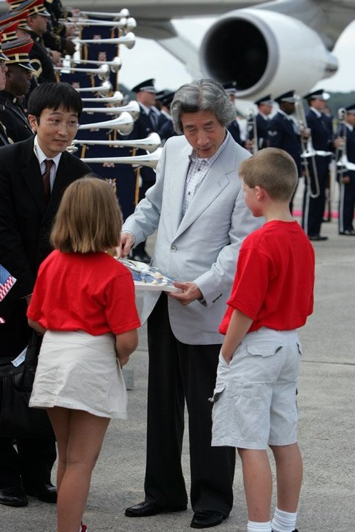 Arriving for the G8 summit at Sea Island, Ga., Japanese Prime Minister Junichiro Koizumi talks with children at Hunter Army Airfield in Savannah, Ga., June 8, 2004. White House photo by Paul Morse