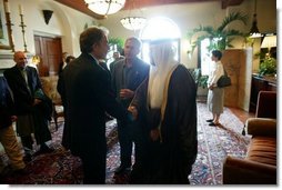 President George W. Bush looks on as Britain's Prime Minister Tony Blair and Iraq's new interim President Ghazi al-Yawer greet each other at the G8 Summit on Sea Island, Ga., Wednesday, June 9, 2004. 