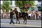 A riderless black horse, with a pair of former President Ronald Reagan's favorite boots turned backward in the stirrups, symbolising the death of a military leader, follows a horse-drawn caisson carrying his casket, Wednesday, June 9, 2004. White House photo by Joyce Naltchayan.