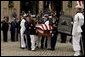 The casket of former President Ronald Reagan is loaded into a hearse at the funeral service at the National Cathedral in Washington, DC on June 11, 2004. White House photo by Paul Morse.
