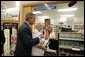 President George W. Bush helps senior Wanda Blackmore buy her prescriptions with her new drug discount card at the Hy-Vee pharmacy in Liberty, Mo., June 14, 2004. White House photo by Paul Morse